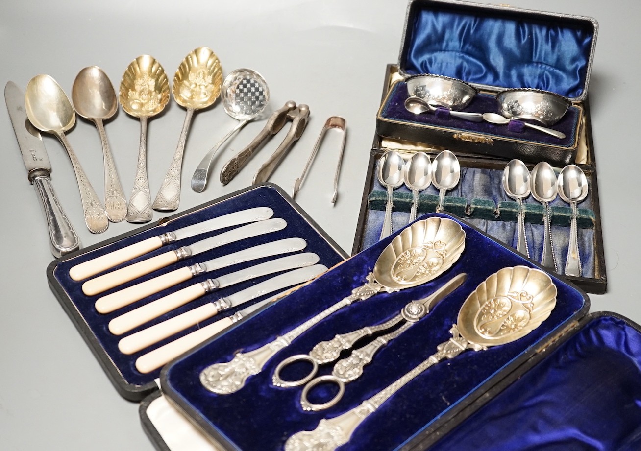 Two pairs of 18th century silver tablespoons including 'berry', a George III silver sifter spoon, pair of sugar tongs and other items including cased plated sets.